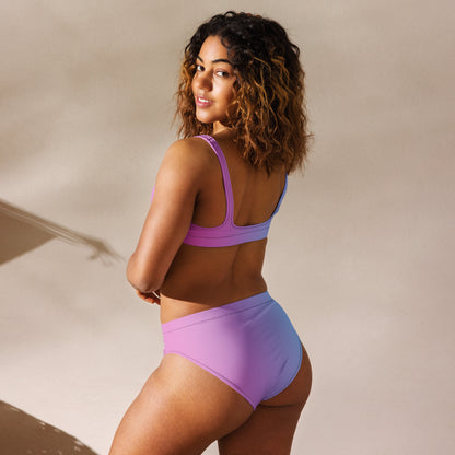 Rear view of woman wearing bikini with color scheme that fades from pink to light blue.