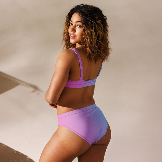 Rear view of woman wearing bikini with color scheme that fades from pink to light blue.