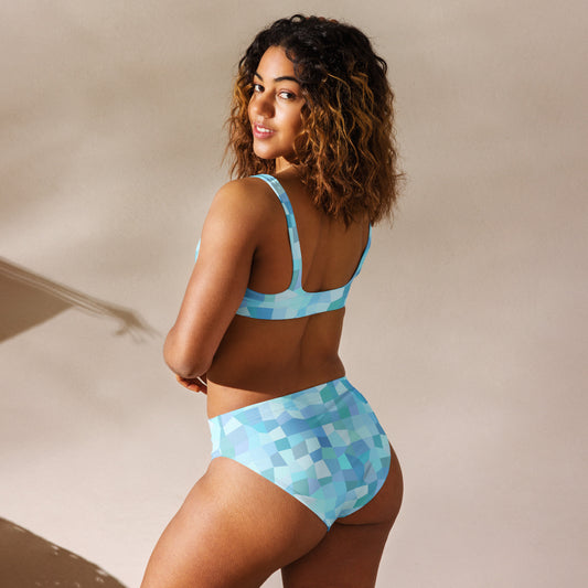 Rear view of woman wearing bikini with cyan geometric pattern.