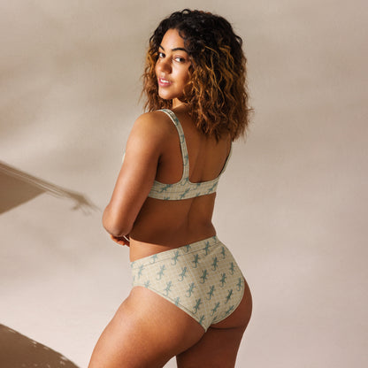 Woman wearing beige bikini with pattern of green geckos.