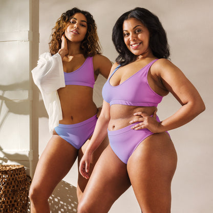 Two women, each wearing bikini with color scheme that fades from light blue to pink.