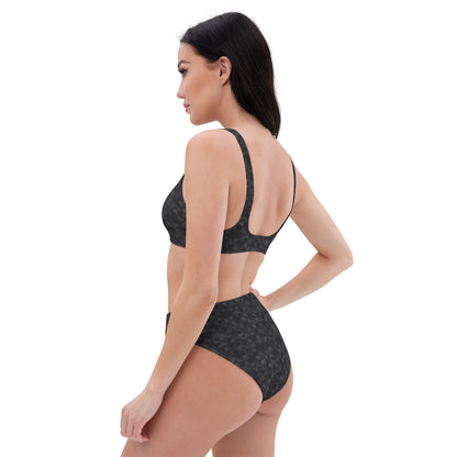 Side view of woman wearing bikini with dark-gray geometric pattern.