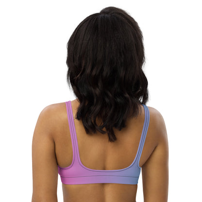 Rear view of woman wearing bikini top with pink-to-blue color scheme.