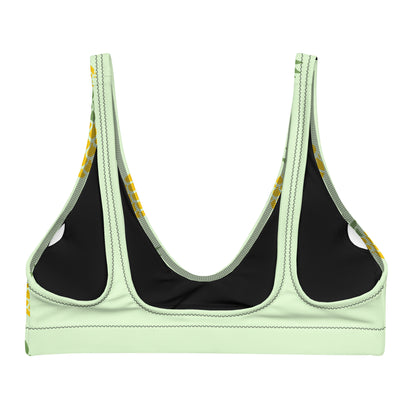 Back of bikini top with all-over pineapple pattern set on a light-green background.