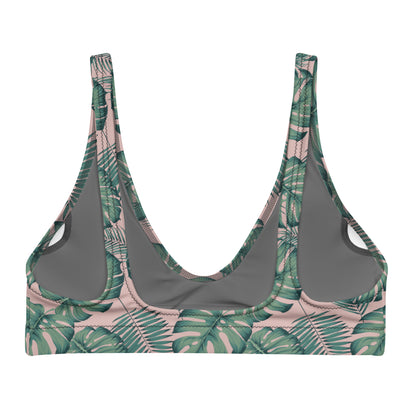 Back of bikini top with pattern of green palm leaves set on a pink background.