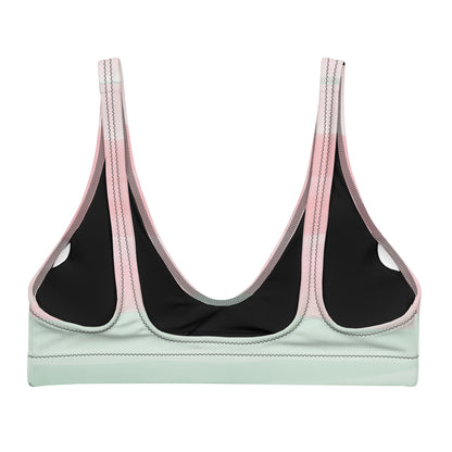 Back of bikini top with design resembling watercolor. Dominant colors are pink and light green.
