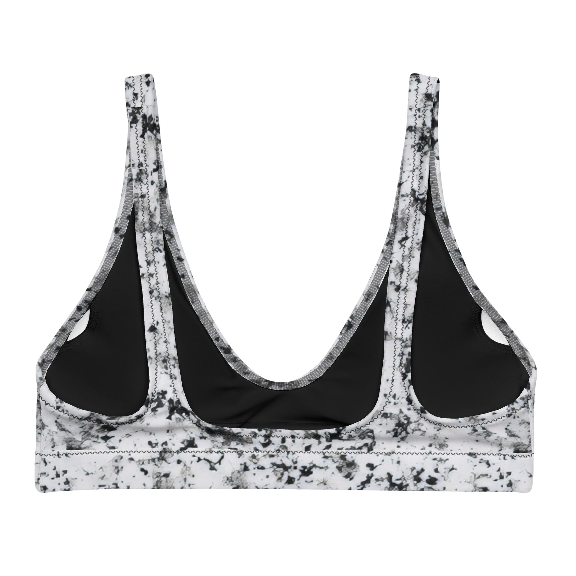 Back of bikini top with pattern of black splotches set on a white background.