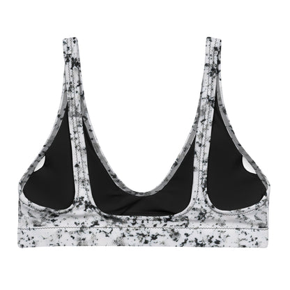 Back of bikini top with pattern of black splotches set on a white background.