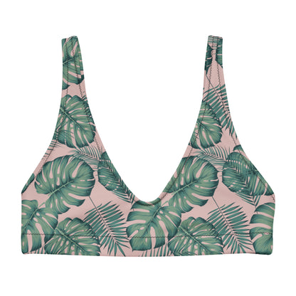 Bikini top with pattern of green palm leaves set on a pink background.