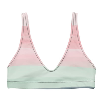 Bikini top with design resembling watercolor. Dominant colors are pink and light green.