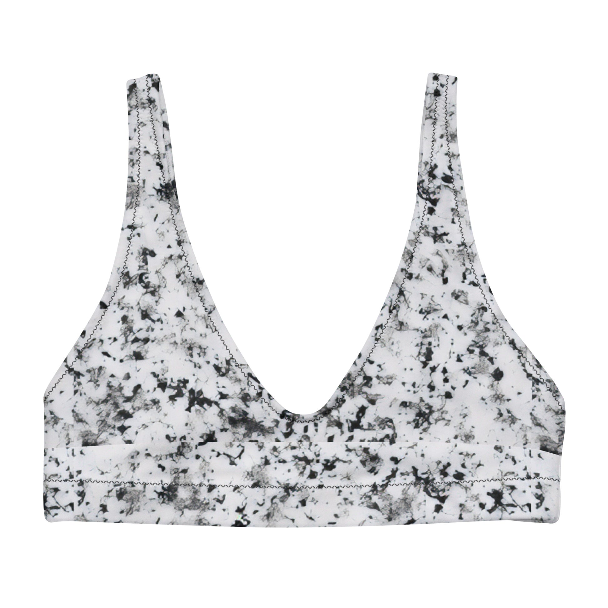 Bikini top with pattern of black splotches set on a white background.
