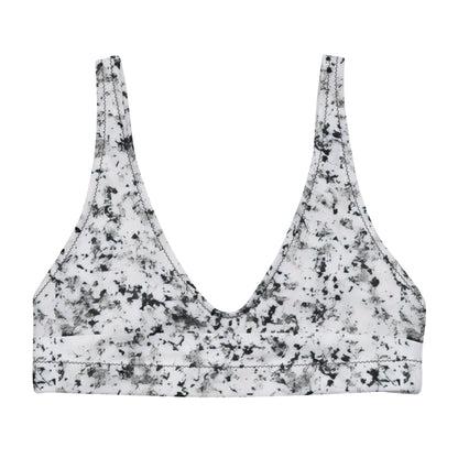 Bikini top with pattern of black splotches set on a white background.