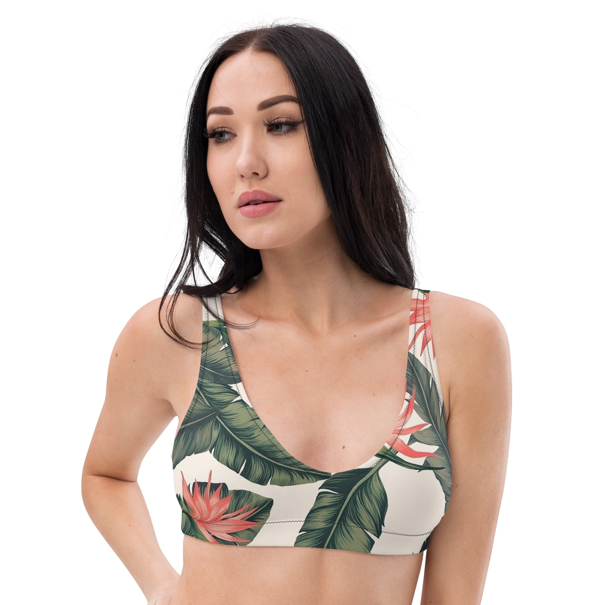 Woman wearing bikini top with tropical floral pattern.