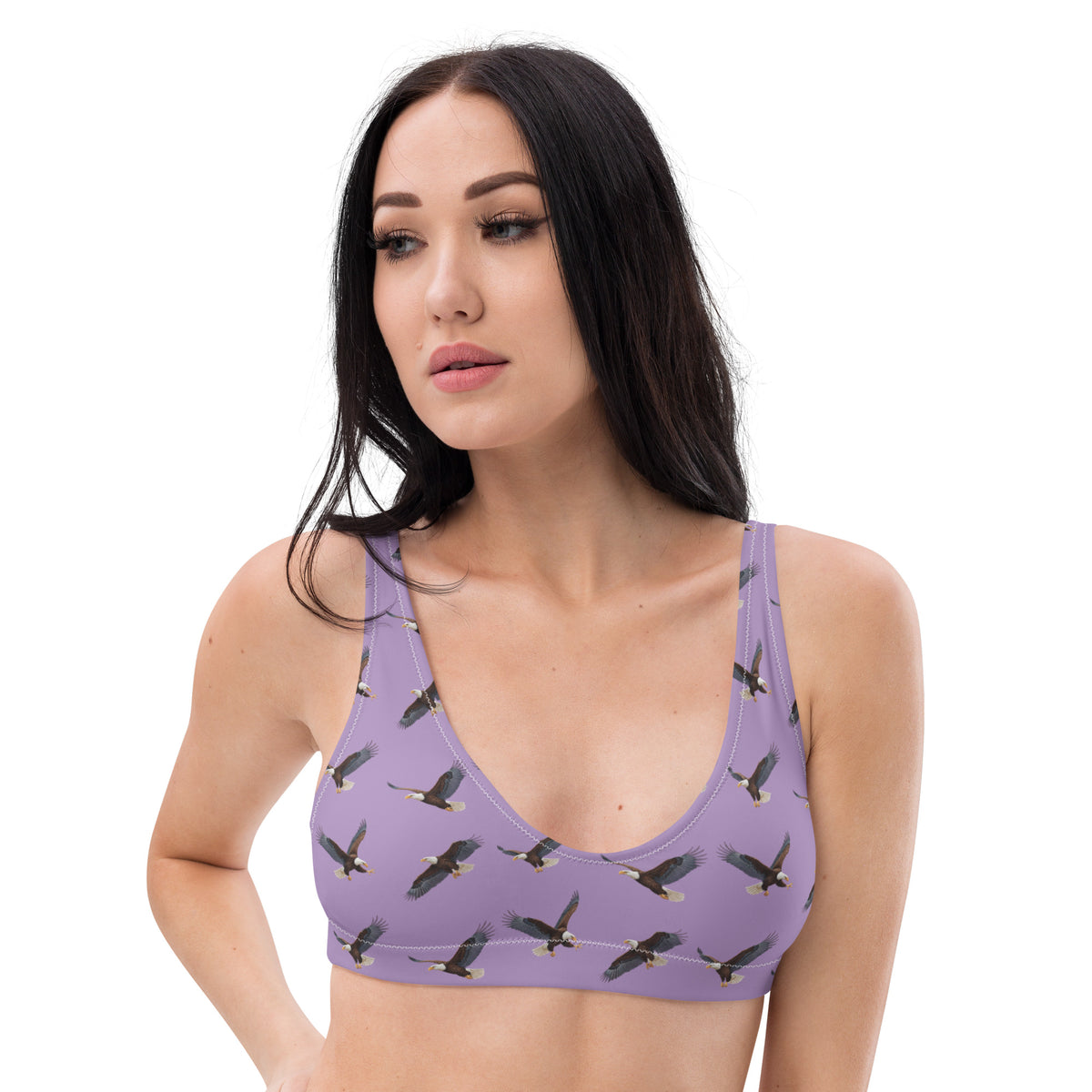 Woman wearing purple bikini top with pattern of bald eagles.