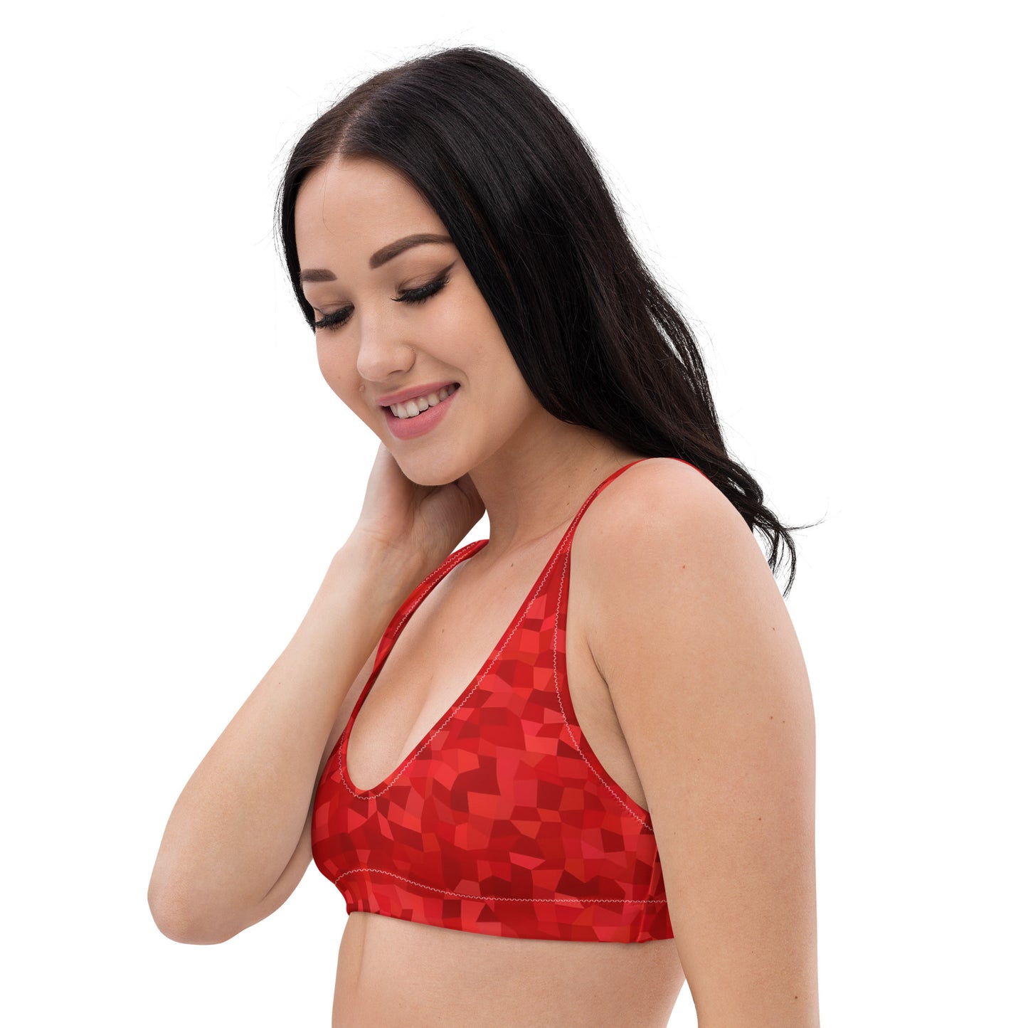 Woman wearing bikini top with red geometric pattern.