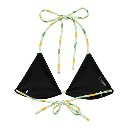 Back of light-green bikini top with all-over pineapple pattern. Interior is black.
