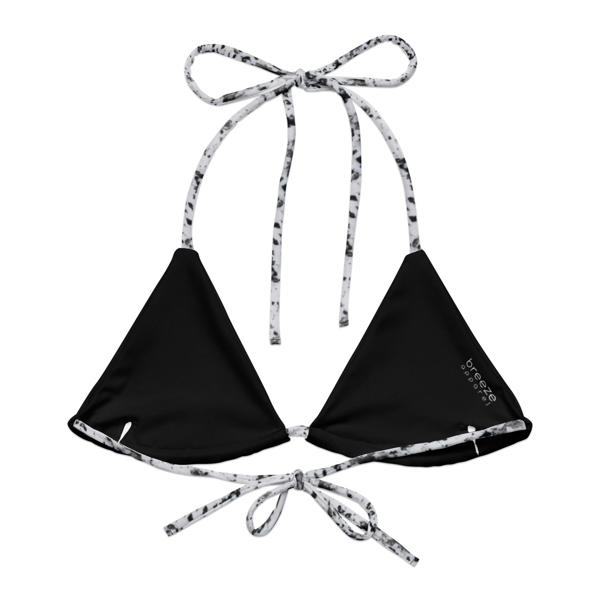Back of bikini top with design of black splotches on a white background. Interior is black.