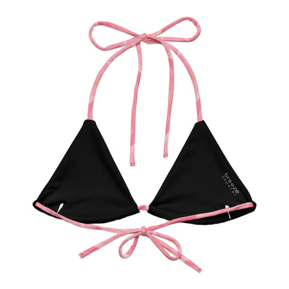Back of bikini top with pink geometric pattern. Interior is black.