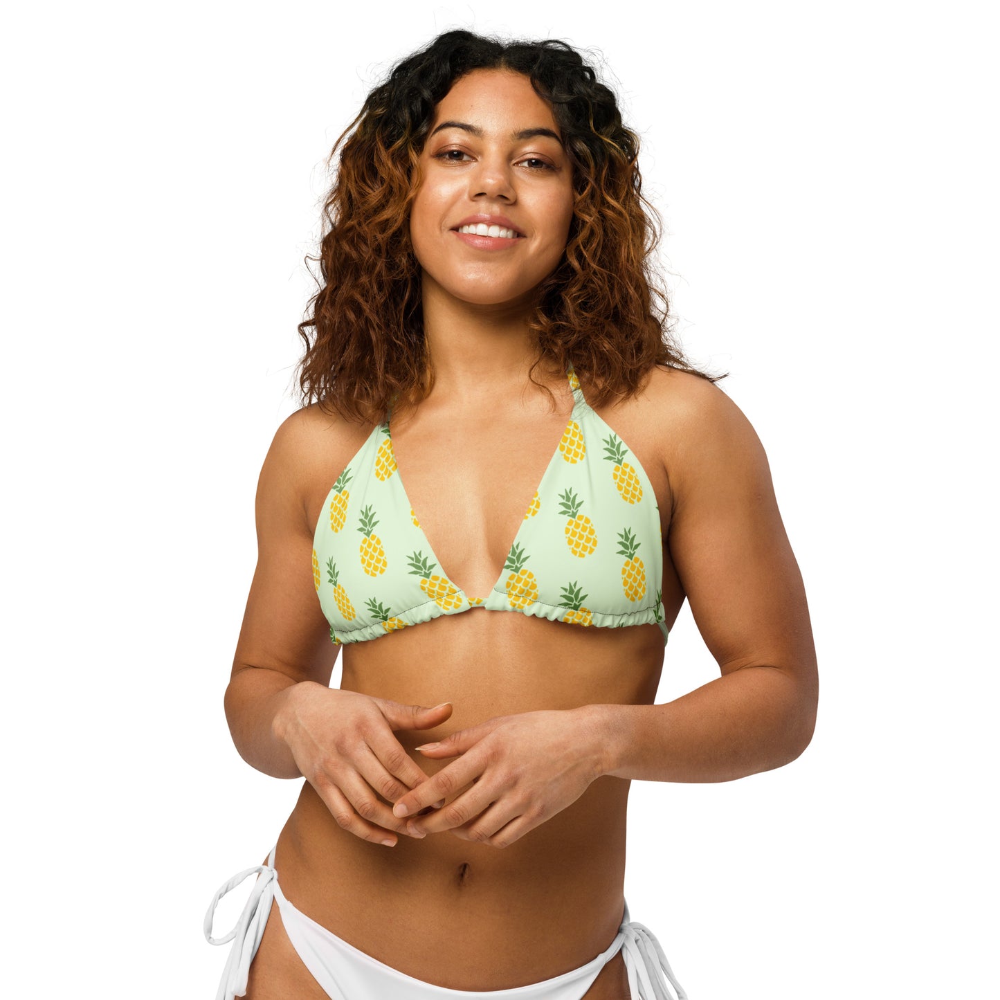 Woman wearing light-green bikini top with all-over pineapple pattern.
