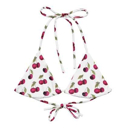 Bikini top with all-over pattern of cherries set on a white background.