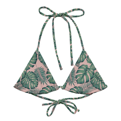 Bikini top with pattern of green palm leaves set on a pink background.