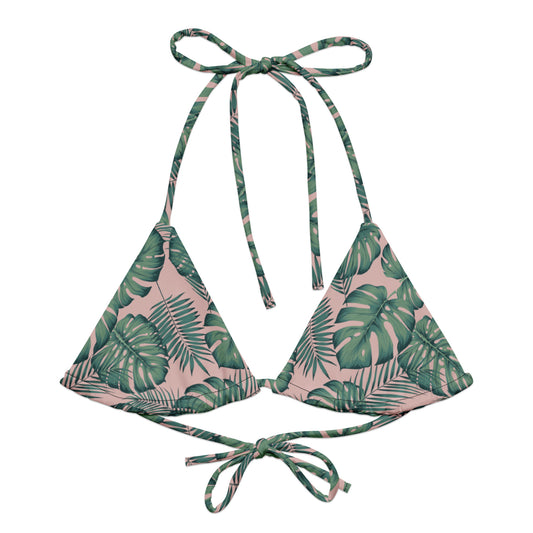 Bikini top with pattern of green palm leaves set on a pink background.