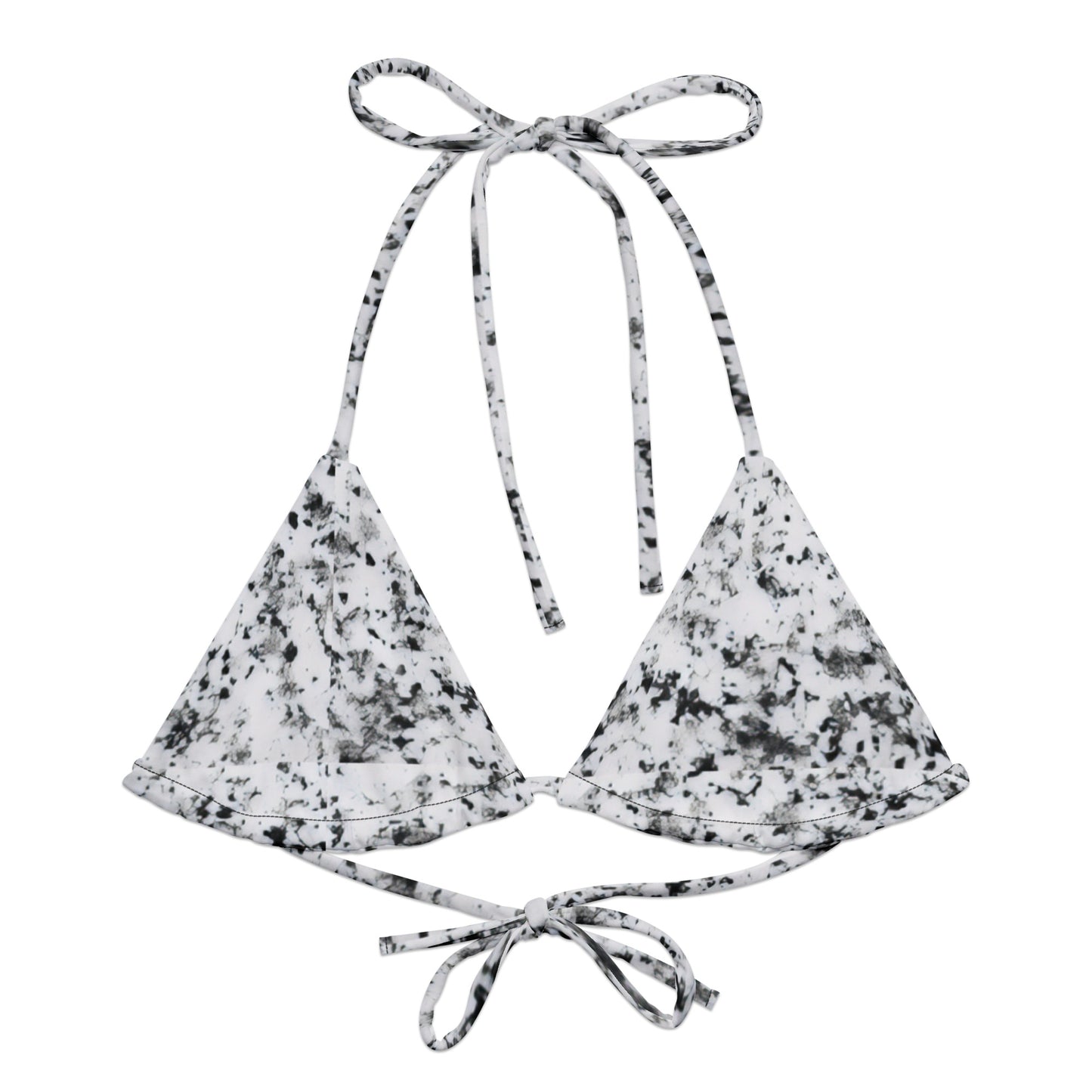 Bikini top with design of black splotches on a white background.