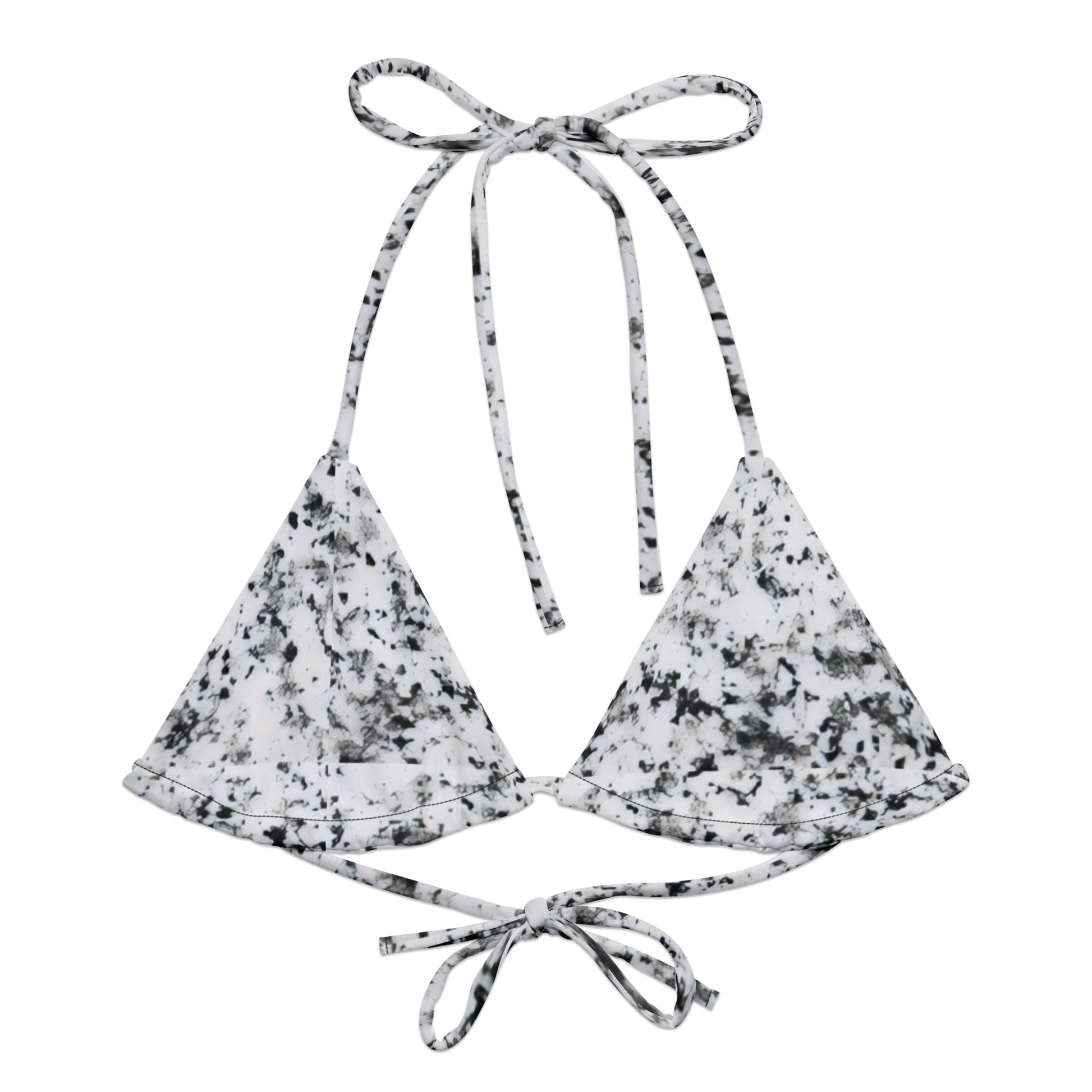 Bikini top with design of black splotches on a white background.