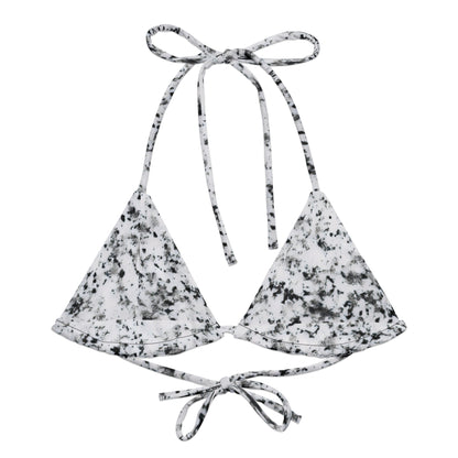 Bikini top with design of black splotches on a white background.