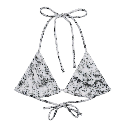 Bikini top with design of black splotches on a white background.
