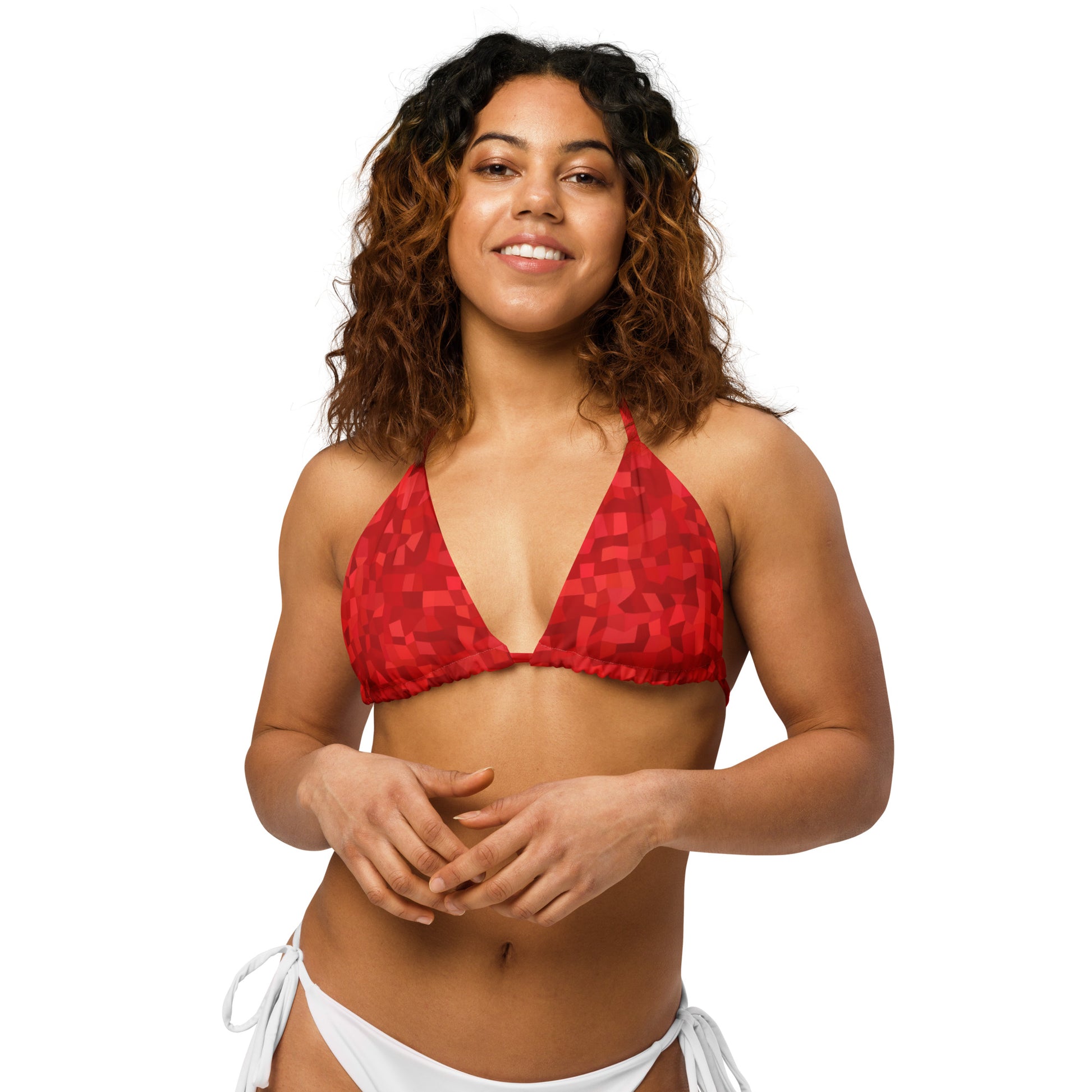 Woman wearing bikini top with red geometric pattern. 