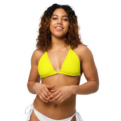 Woman wearing yellow bikini top.