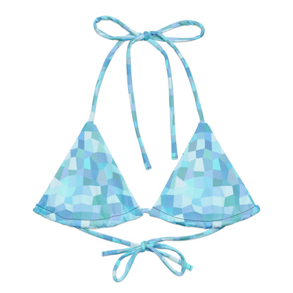 Bikini top with cyan geometric pattern.