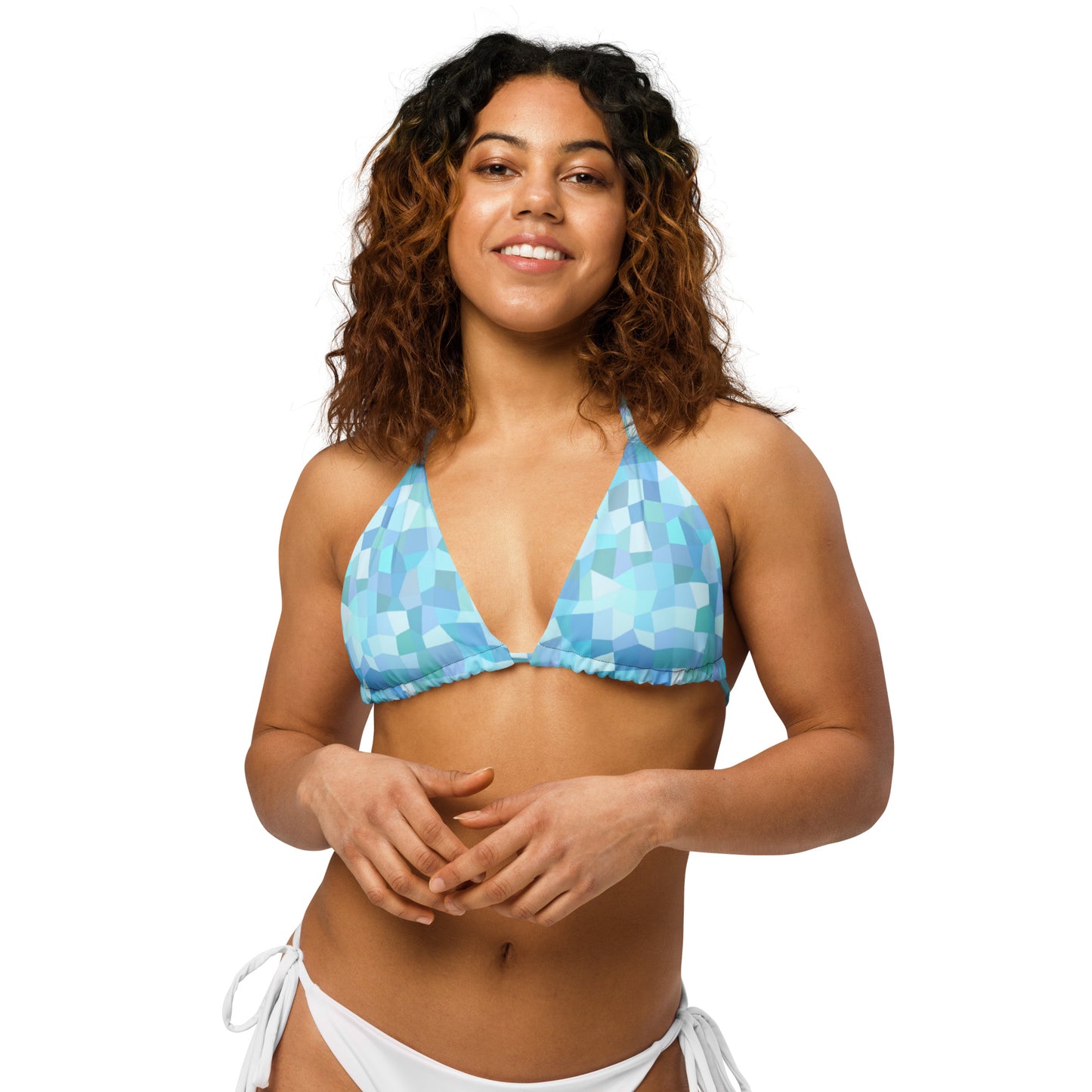 Woman wearing bikini top with cyan geometric pattern.