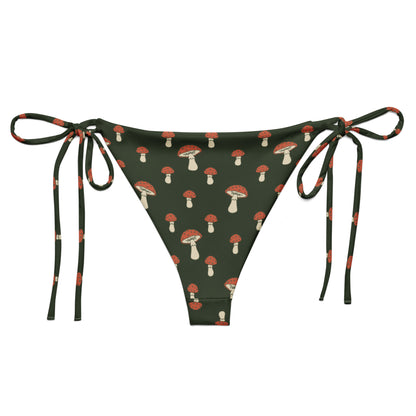 Back of bikini bottom with pattern of mushrooms set on a forest-green background.