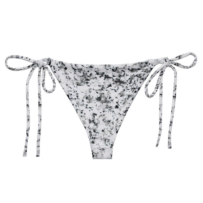 Back of bikini bottom with design of black splotches on a white background.
