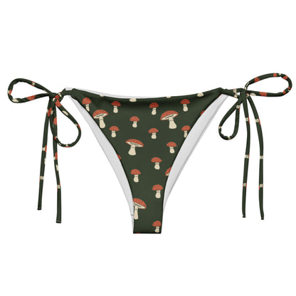Bikini bottom with pattern of mushrooms set on a forest-green background.
