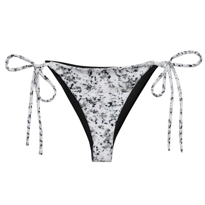 Bikini bottom with design of black splotches on a white background.