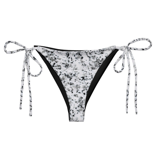 Bikini bottom with design of black splotches on a white background.