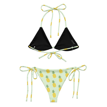 Back of light-green bikini with all-over pineapple pattern. Interior is black.