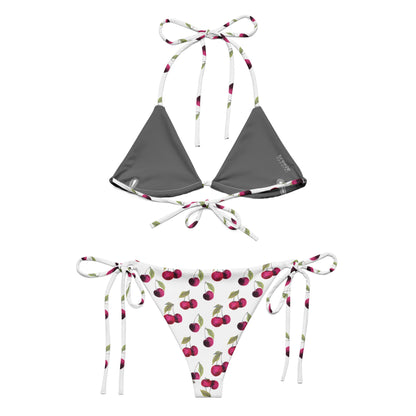 Back of bikini with all-over pattern of cherries set on a white background.