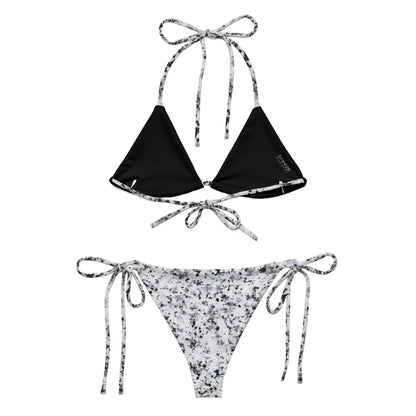 Back of bikini with design of black splotches on a white background. Interior is black.