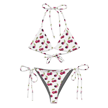 Bikini with all-over pattern of cherries set on a white background.