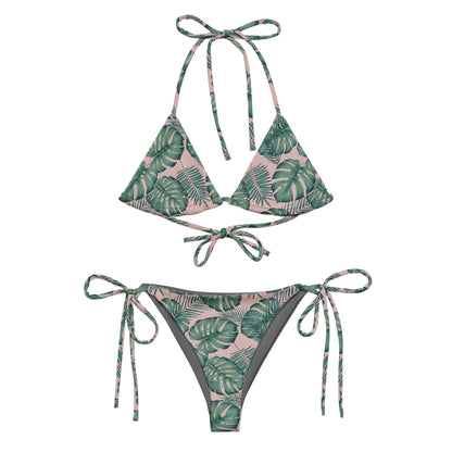 Bikini with pattern of green palm leaves set on a pink background.