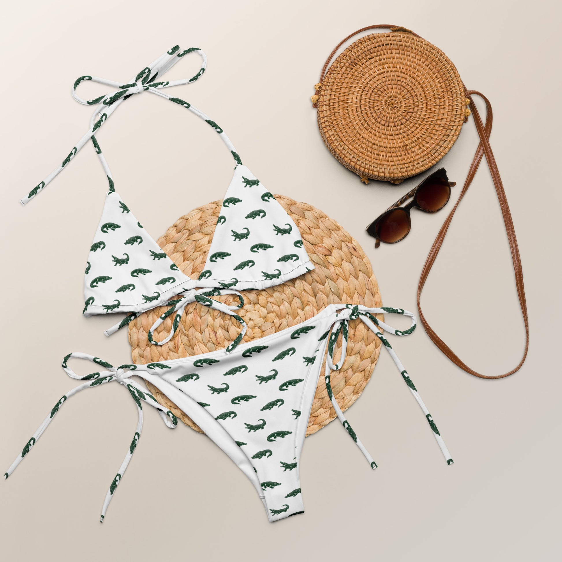 White bikini with pattern of green alligators.