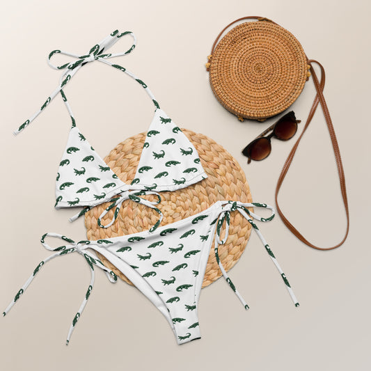 White bikini with pattern of green alligators.