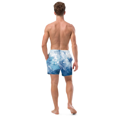 Rear view of man wearing swim trunks with a blue-white watercolor pattern.