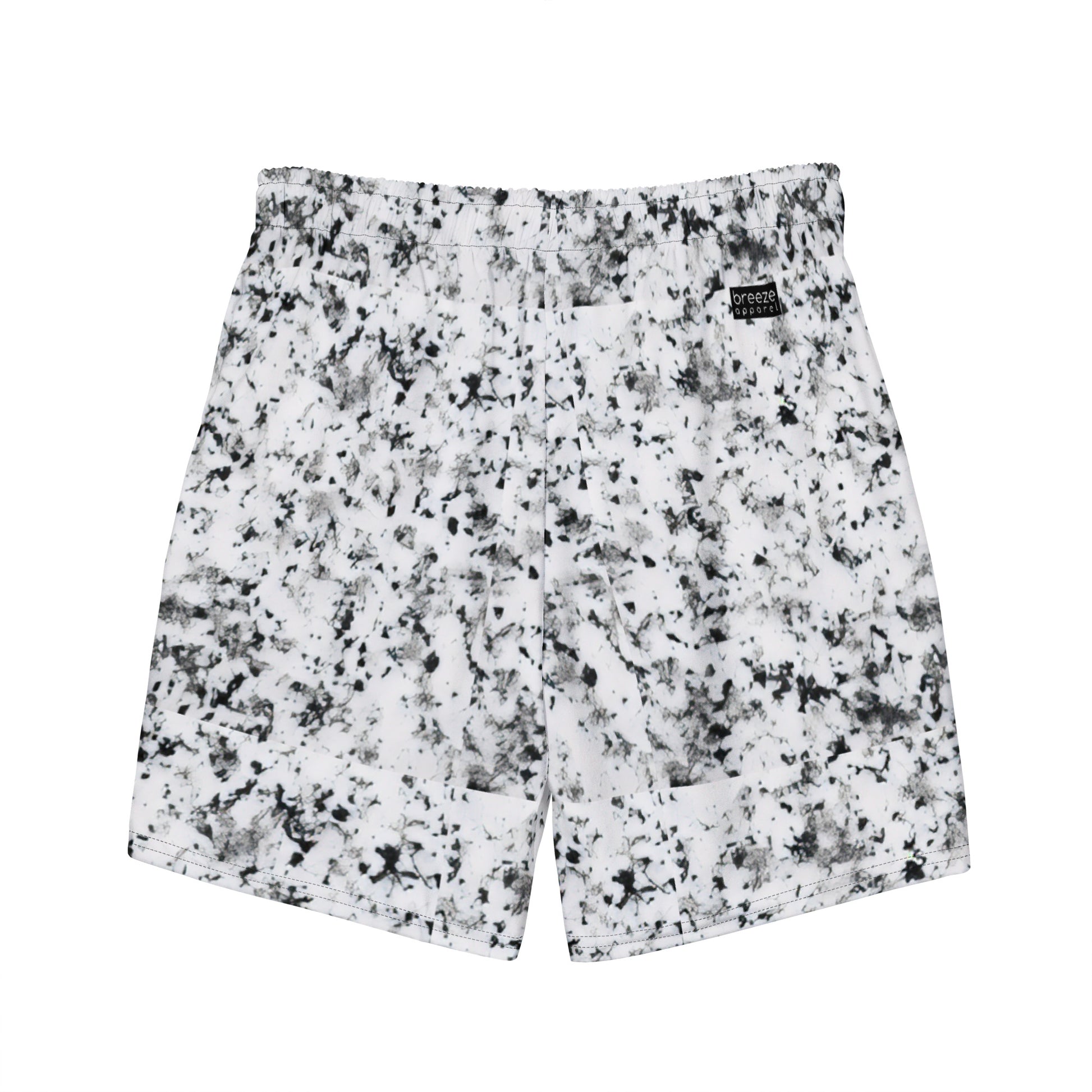 Back of swim trunks with pattern of black splotches on a white background.