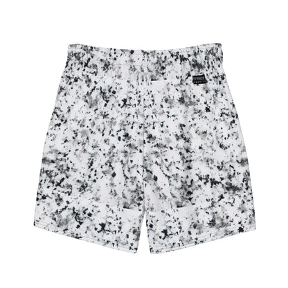 Back of swim trunks with pattern of black splotches on a white background.