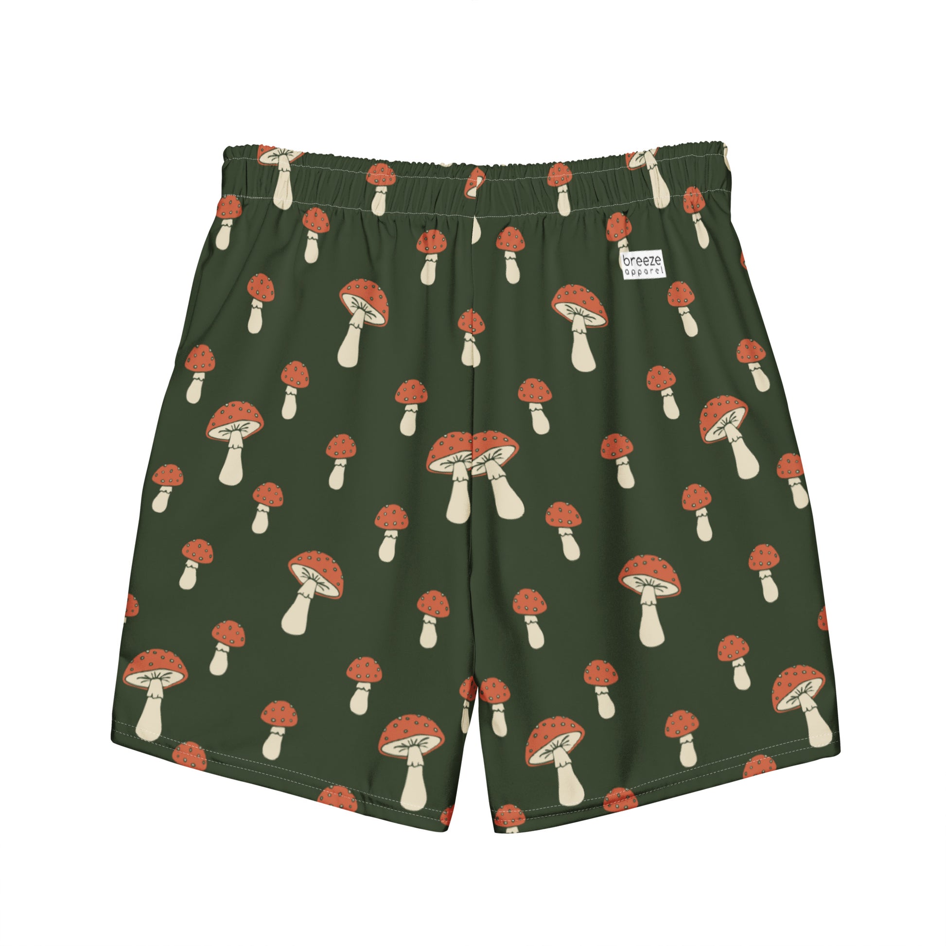 Swim trunks with pattern of mushrooms on a green background.
